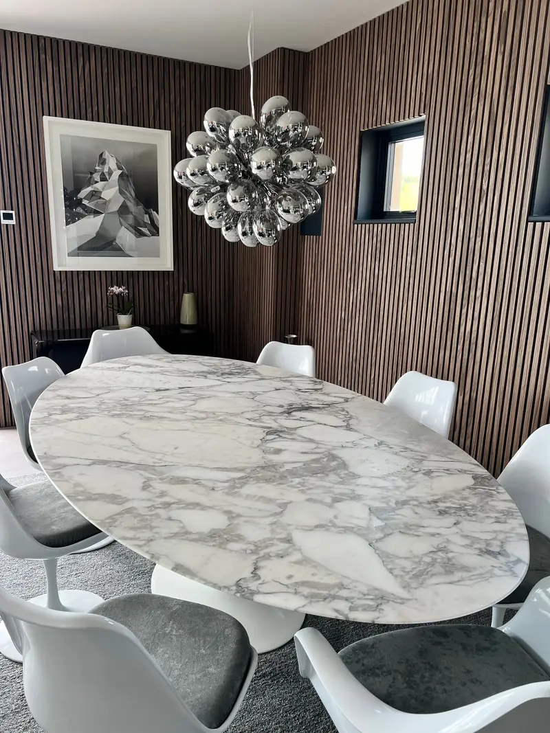 Dining area with marble table and white chairs